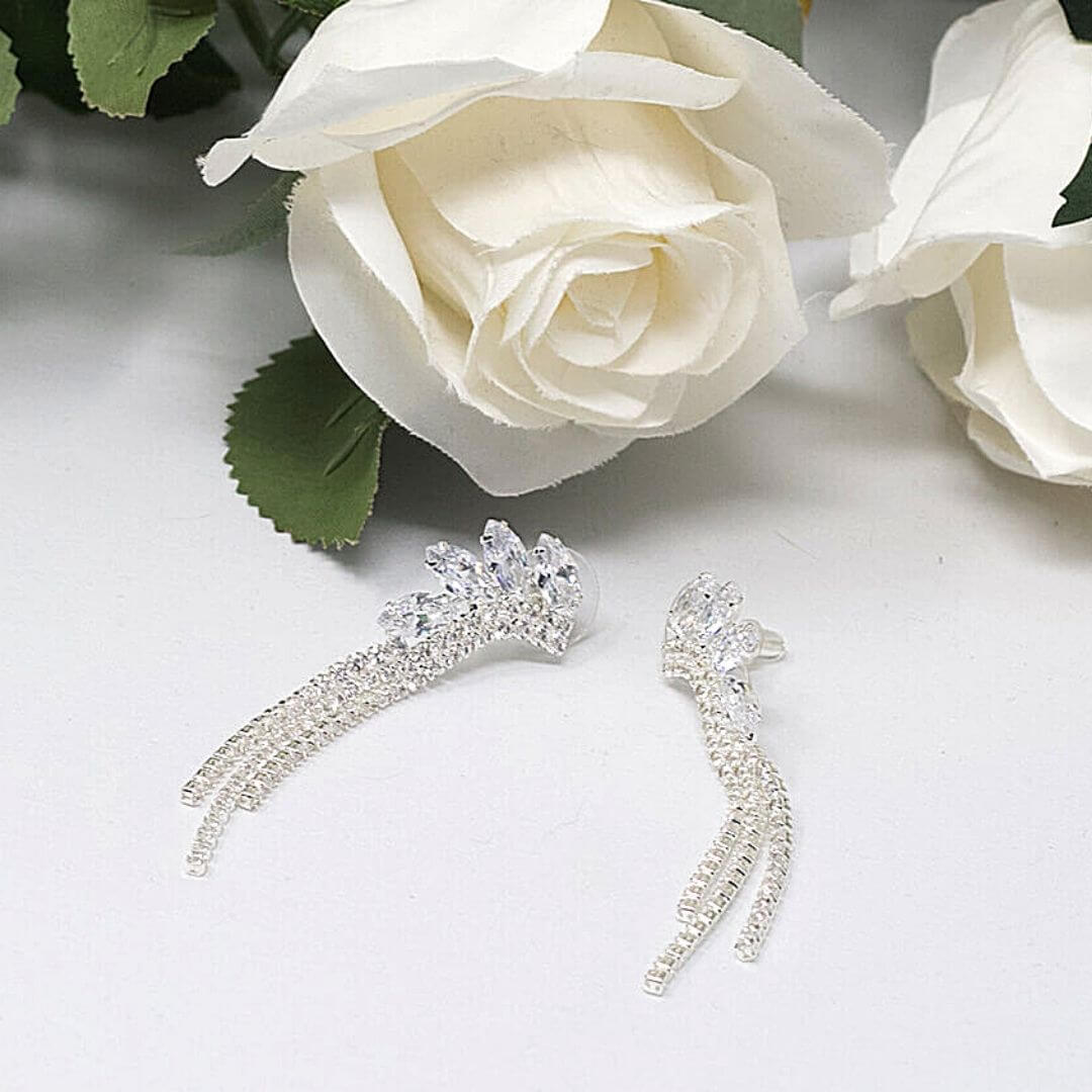 Clear Earrings presented flat with flowers in the background - BELLE DE SOIREE Natalia Clear Earrings