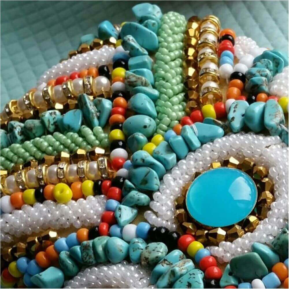 Colourful beads shown flat on a blue background- Belle de Soiree beaded bag Josephine for daytime or evenings