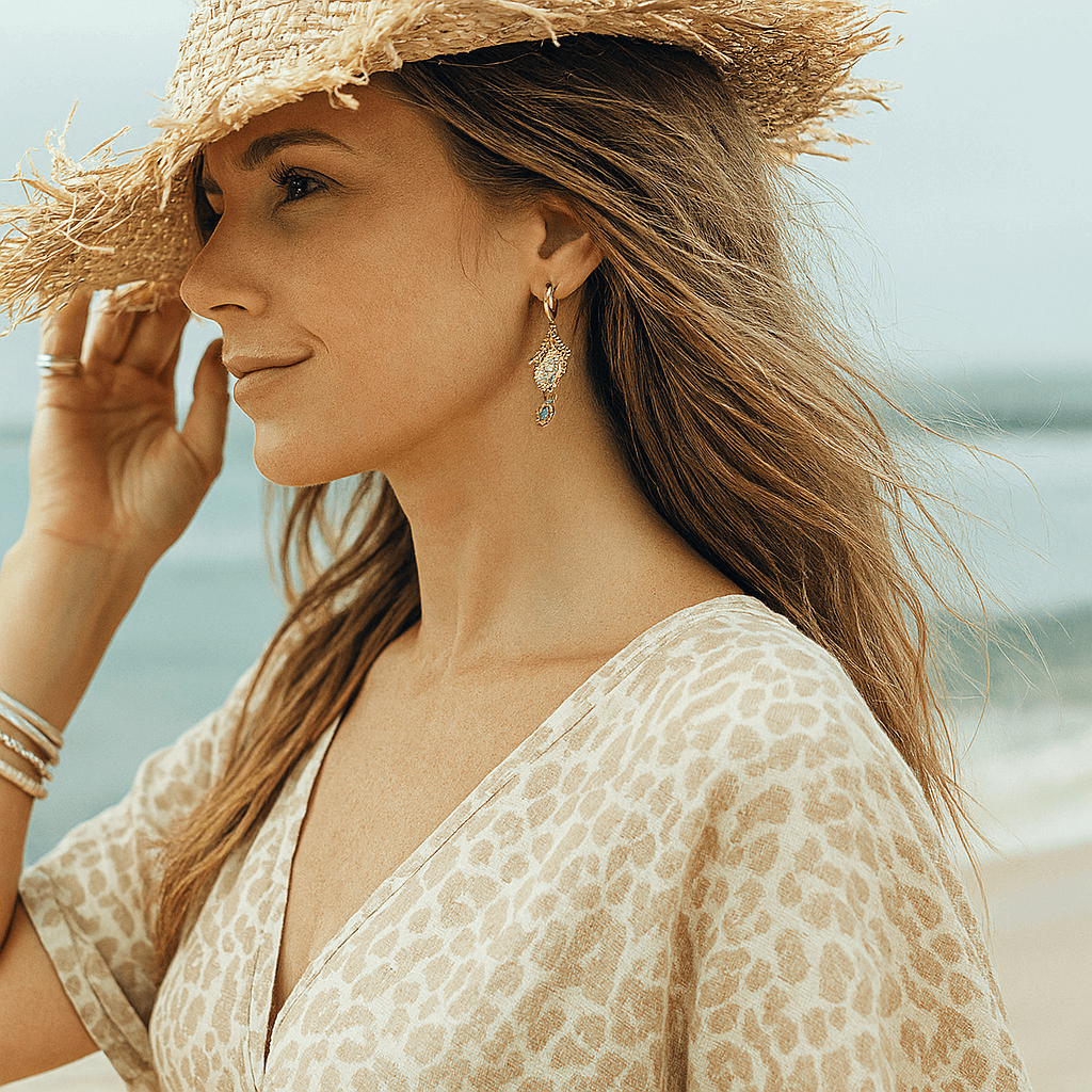 Woman wearing a straw hat and leopard print dress on a beach