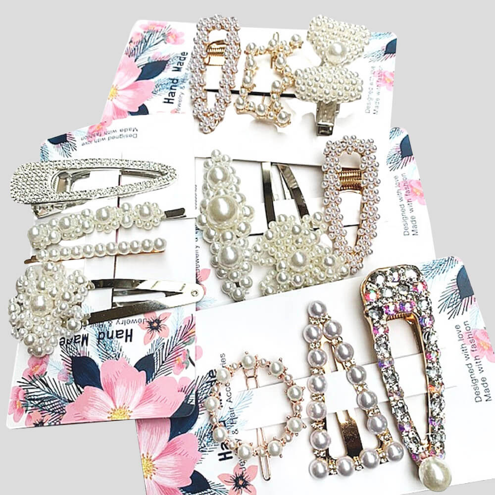 Collection of pearl and rhinestone hair accessories on floral-patterned paper