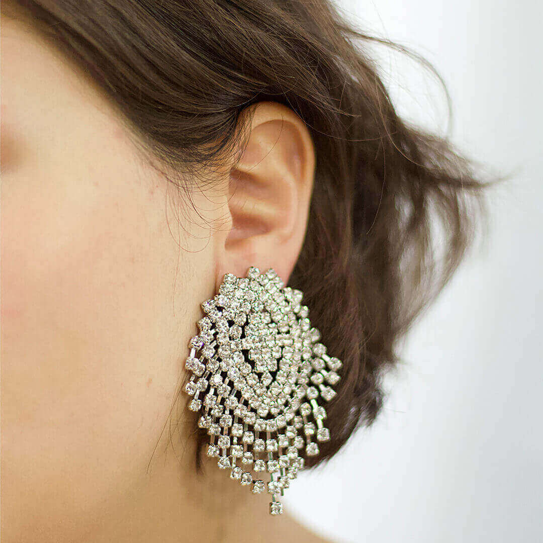 Close-up of a person wearing a Rhinestone Big Stud earring -Belle de Soiree