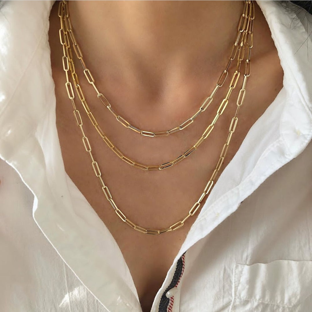 Gold chain necklace on a white shirt