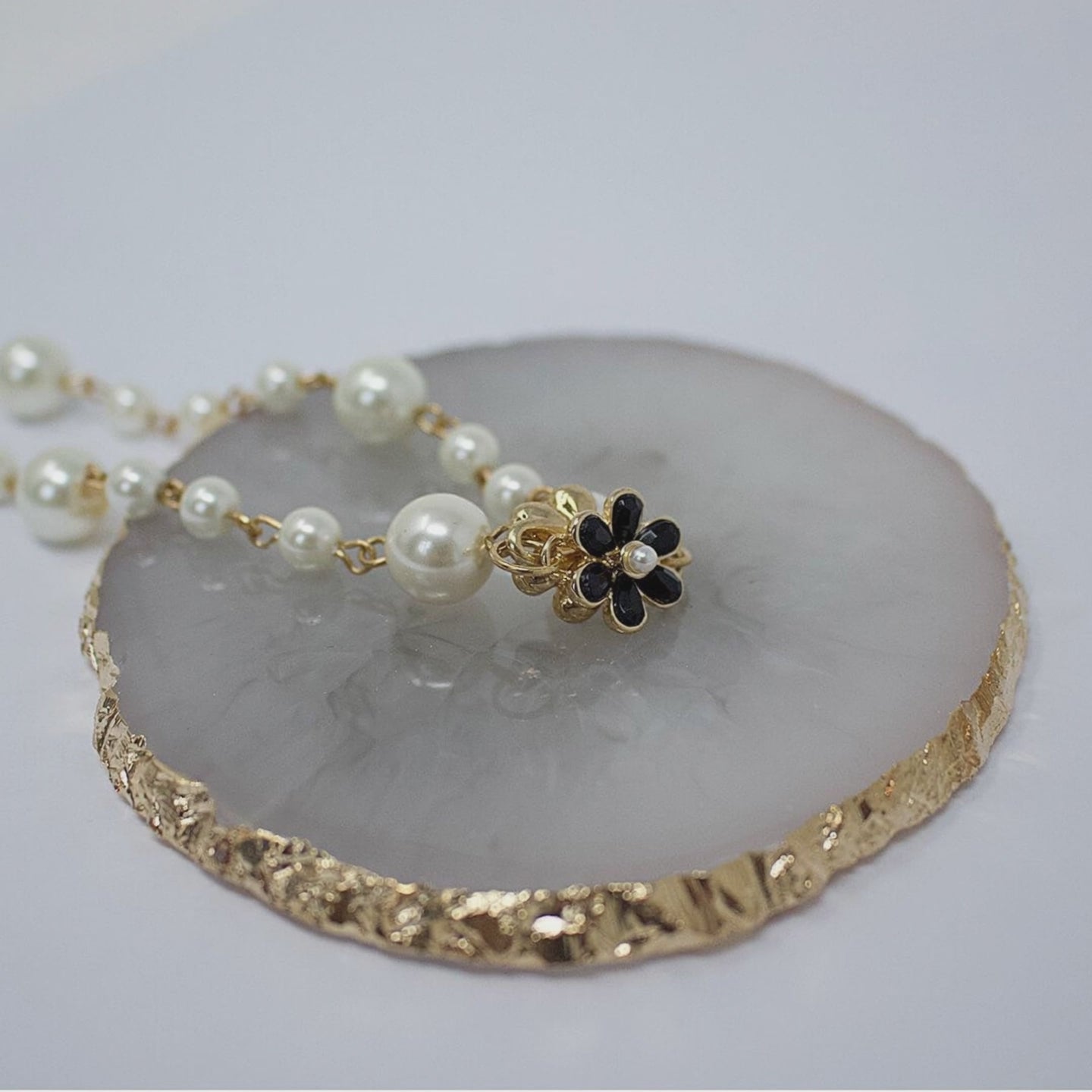 a model is putting on a pearl necklace-belle de soiree irina