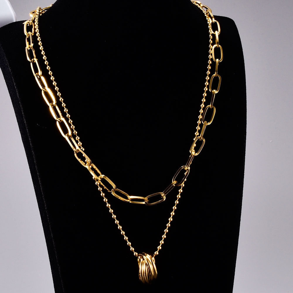 18K Gold Plated Circular Long Link Necklace shown on a black display- BELLE DE SOIREE chunky gold pendant