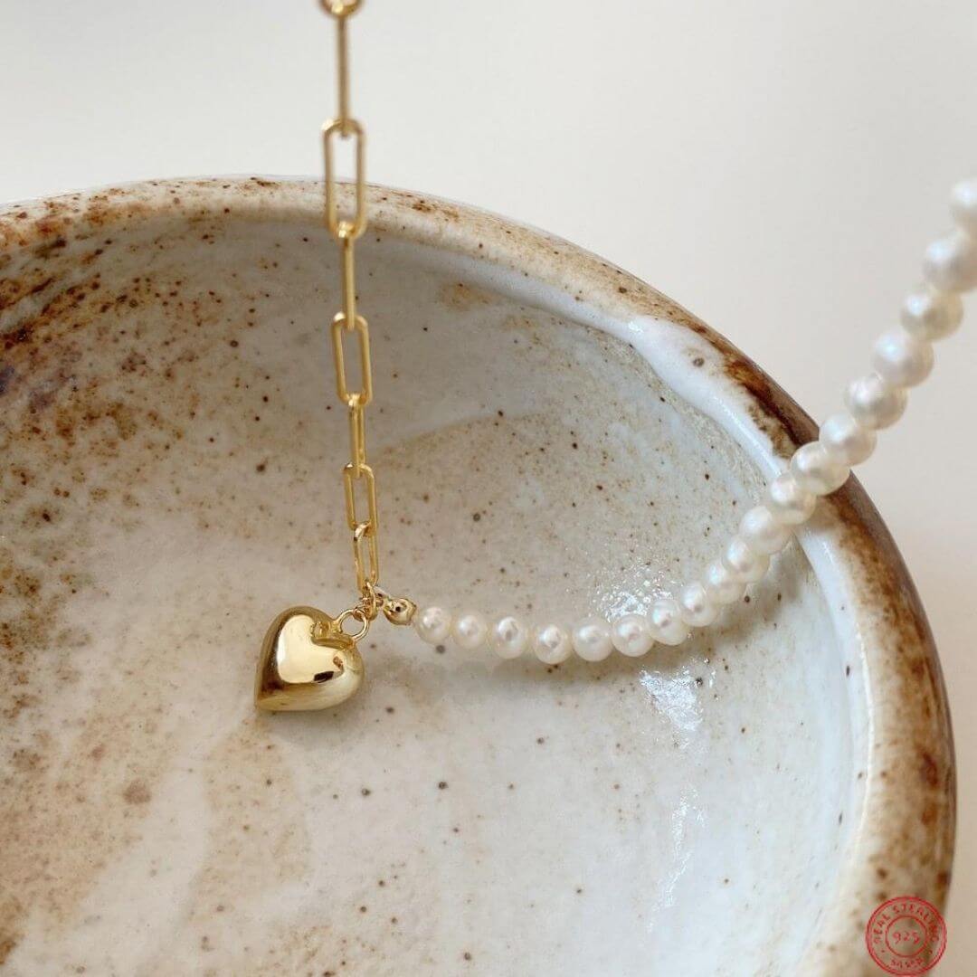 Asymmetrical Chain Heart Necklace shown on a plate- BELLE DE SOIREE chain heart necklace