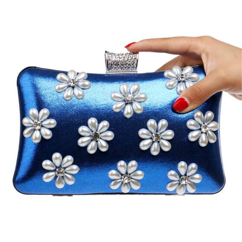 Blue LILI EVENING BAG shown by a woman's hand- Belle de Soiree colourful clutch bag Lili