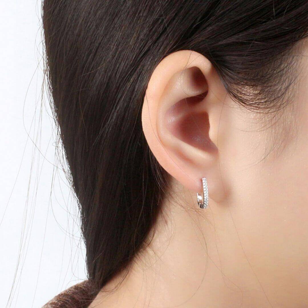 Genuine Silver Oval Hoop Earrings shown on a model- BELLE DE SOIREE small genuine silver hoop earrings; Perfect for glamorous parties, dinners, and more.