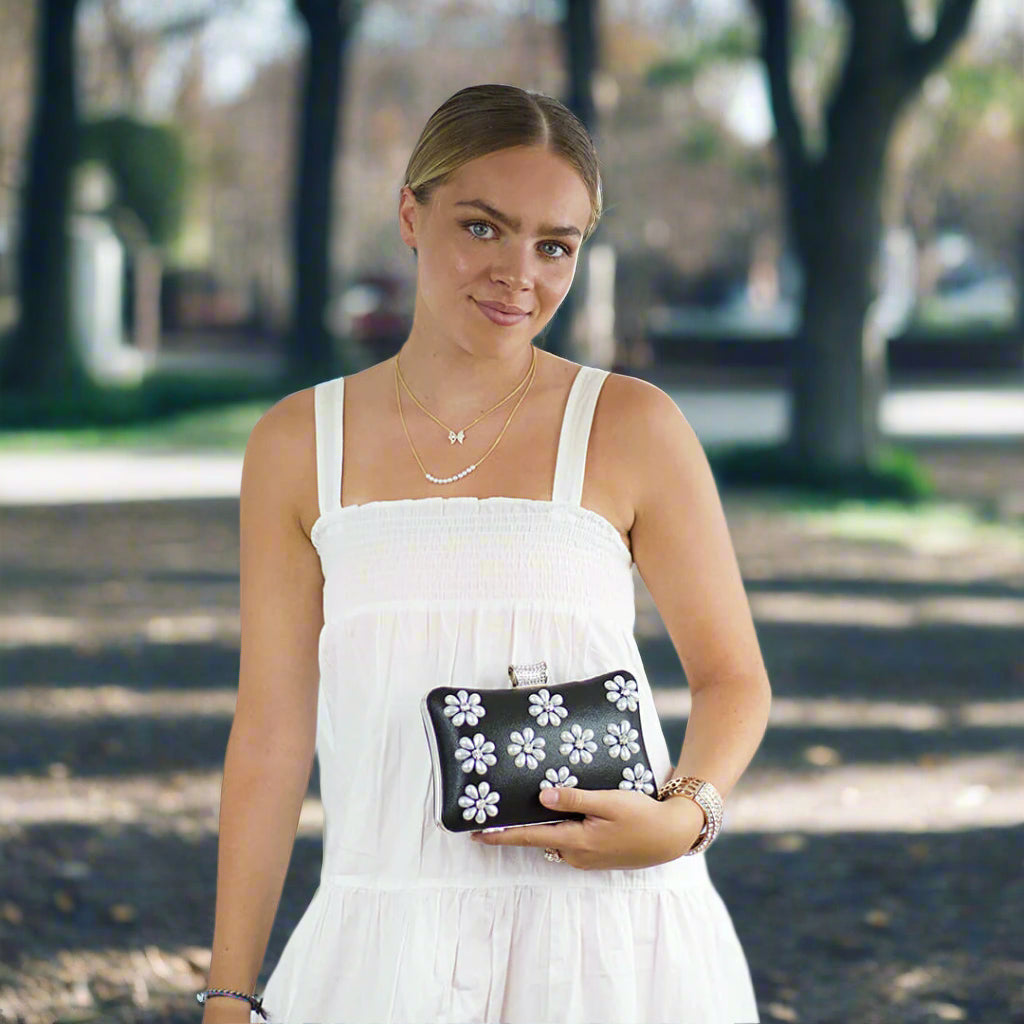 Lili Evening Bag worn by a woman in a white dress in a park background-Belle de Soiree Lili Evening Bag