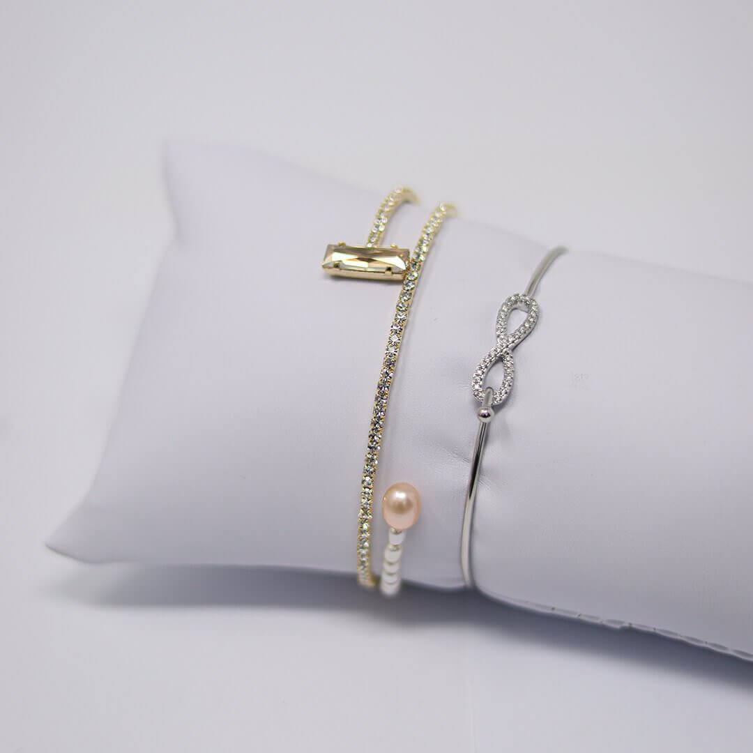 Platinum-Plated infinity bracelet shown with another bracelet on a white display- BELLE DE SOIREE Platinum-Plated infinity bracelet