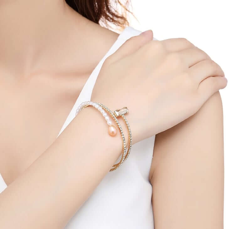 Riviera Champagne 18K Gold-plated Bangle shown on a model with her hand on her shoulder- BELLE DE SOIREE Riviera gold bracelet