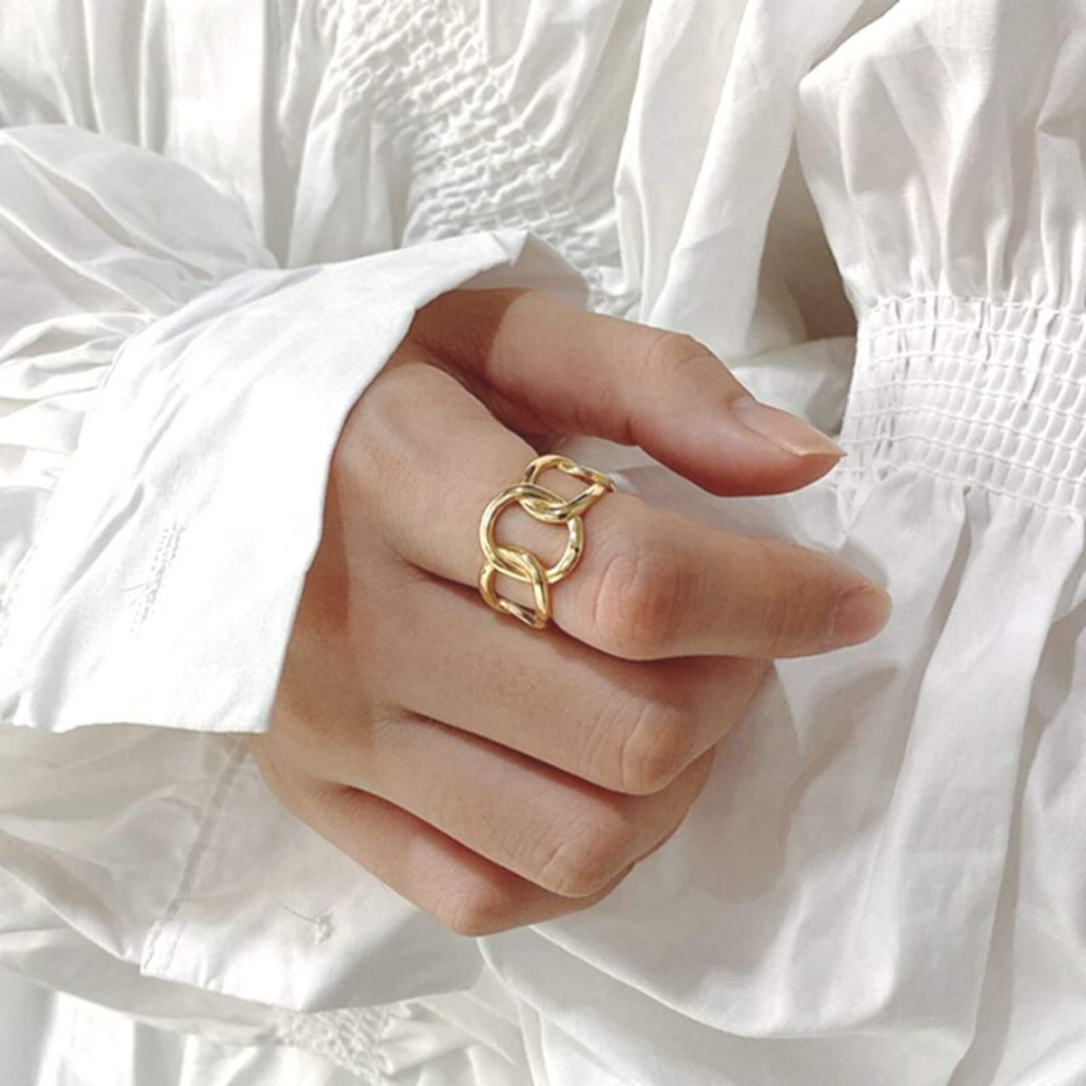 Show-stopping Gold Plate Link Ring shown on a model wearing a white shirt- BELLEDESOIREE gold ring