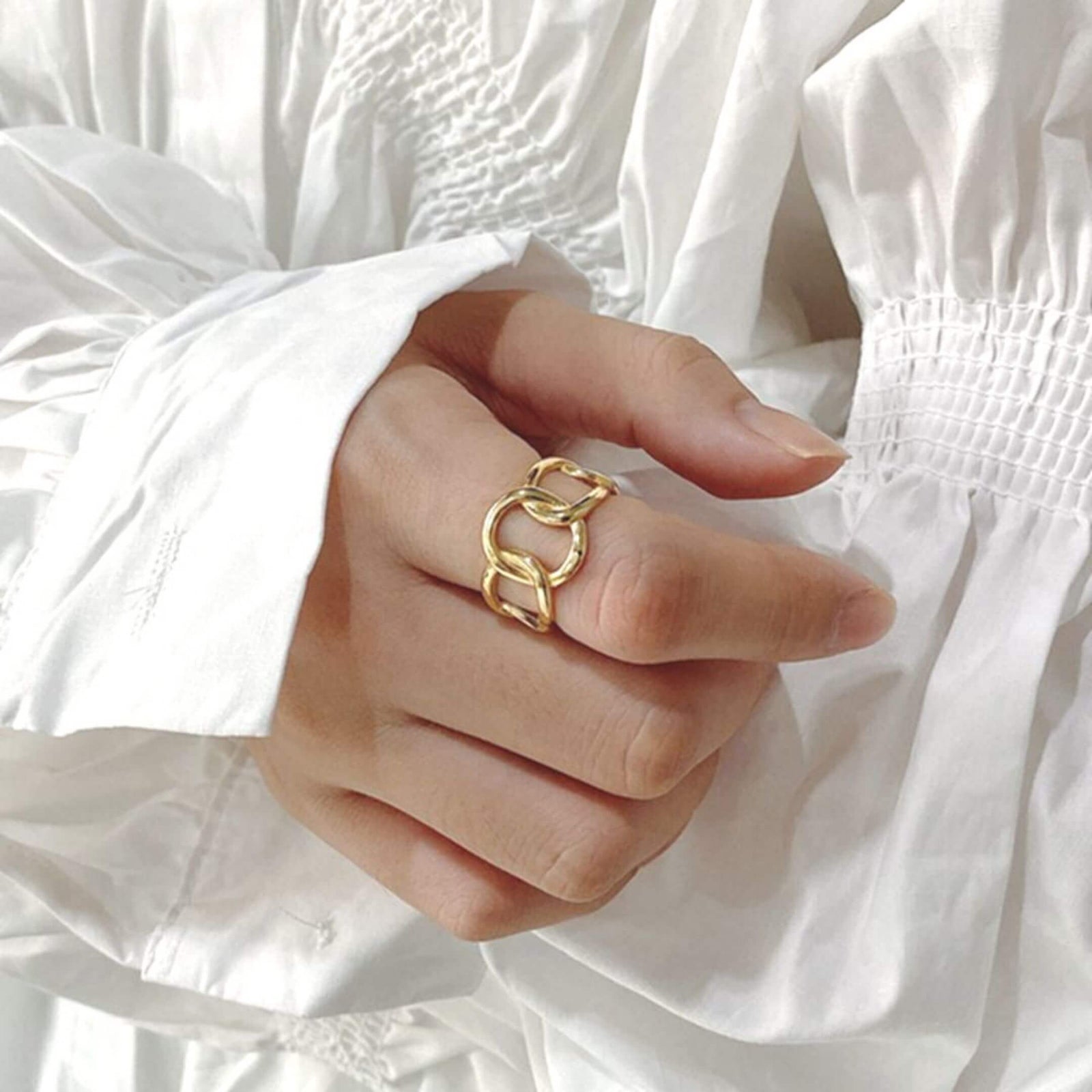 Show-stopping Gold Plate Link Ring shown on a model wearing a white shirt- BELLEDESOIREE gold ring
